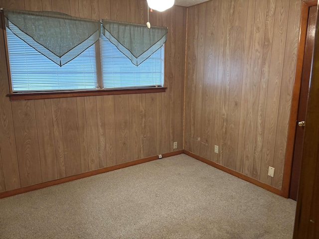 1001 Macarthur Dr, Port Neches, TX 77651 - empty room featuring baseboards, carpet flooring, and wood walls