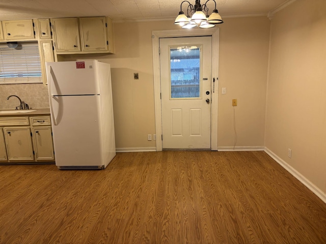 1001 Macarthur Dr, Port Neches, TX 77651 - kitchen with a sink, crown molding, freestanding refrigerator, and wood finished floors