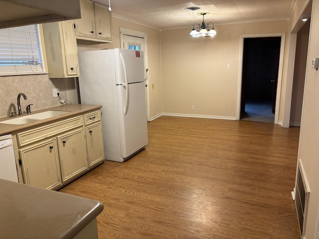 1001 Macarthur Dr, Port Neches, TX 77651 - kitchen featuring a sink, decorative backsplash, white appliances, and ornamental molding