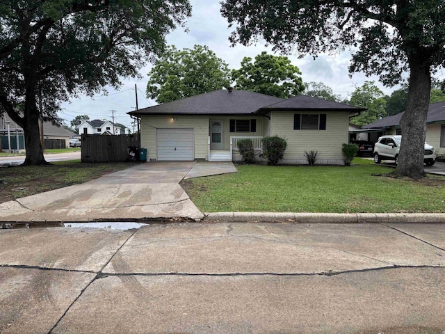 1001 Macarthur Dr, Port Neches, TX 77651 - view of front of house featuring fence, an attached garage, driveway, and a front lawn