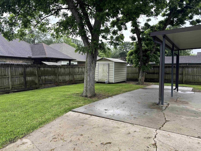 1001 Macarthur Dr, Port Neches, TX 77651 - view of yard with a storage shed, an outbuilding, a fenced backyard, and a patio area