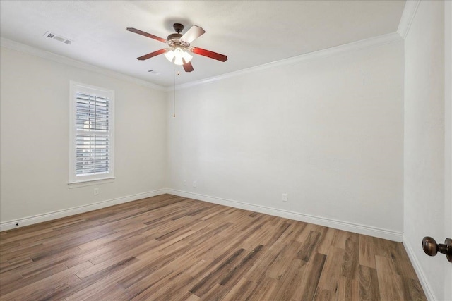 unfurnished room featuring crown molding and wood finished floors