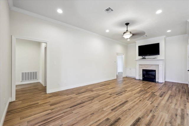 unfurnished living room with light wood-style floors and visible vents