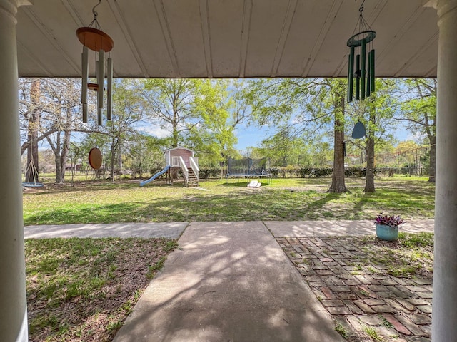 view of yard with a playground and a trampoline