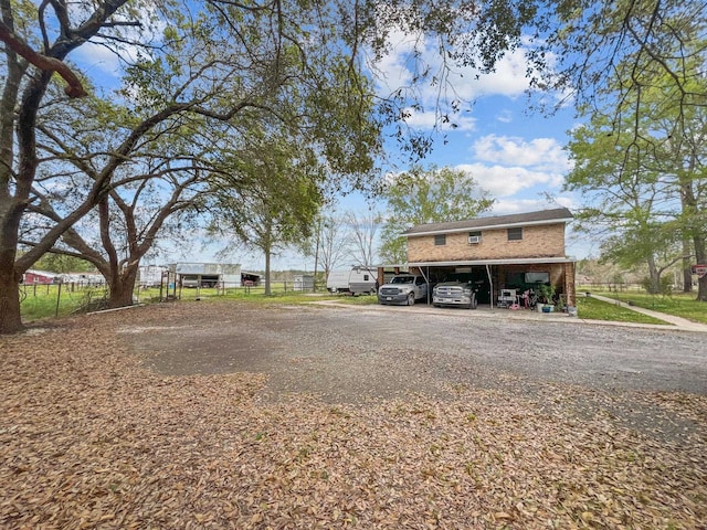 exterior space with a carport and fence