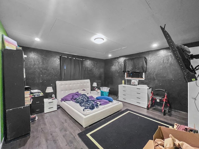 bedroom featuring recessed lighting and wood finished floors