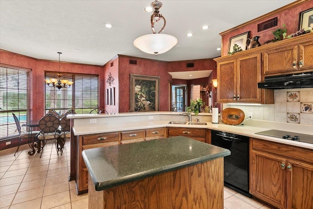 3495 Briar Way, Beaumont, TX 77706 - kitchen with black appliances, under cabinet range hood, brown cabinetry, a peninsula, and a chandelier