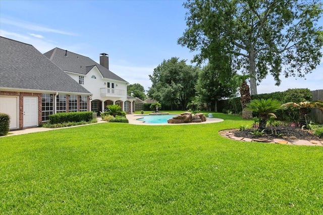 3495 Briar Way, Beaumont, TX 77706 - view of green lawn with a balcony, an outdoor pool, and a patio
