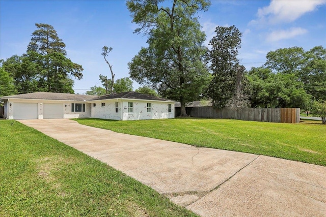 5520 N Circuit Dr, Beaumont, TX 77706 - view of front of property featuring concrete driveway, an attached garage, fence, and a front yard