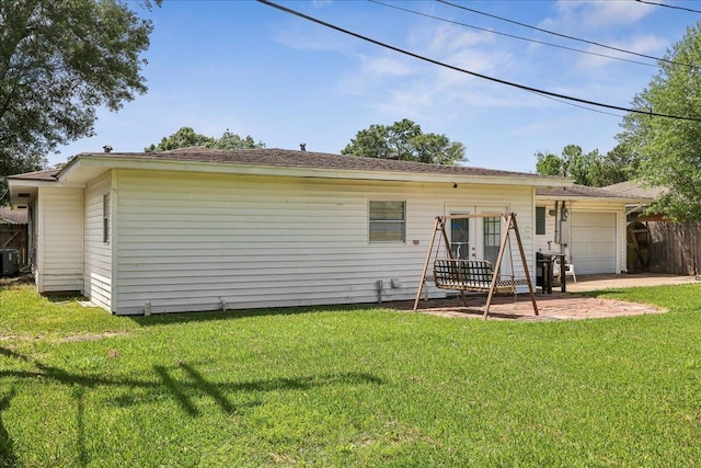 5520 N Circuit Dr, Beaumont, TX 77706 - back of house with a garage, cooling unit, a lawn, and fence