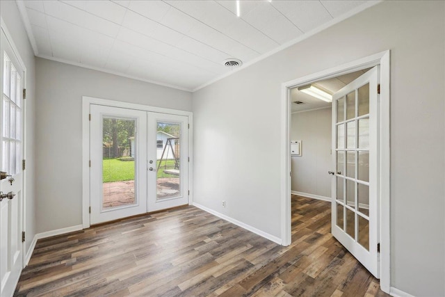 5520 N Circuit Dr, Beaumont, TX 77706 - spare room featuring baseboards, french doors, wood finished floors, and crown molding