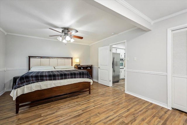 5520 N Circuit Dr, Beaumont, TX 77706 - bedroom featuring stainless steel fridge with ice dispenser, crown molding, light wood-style floors, and baseboards