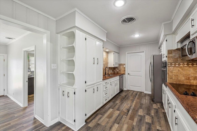 5520 N Circuit Dr, Beaumont, TX 77706 - kitchen featuring white cabinets, dark countertops, visible vents, dark wood-type flooring, and appliances with stainless steel finishes