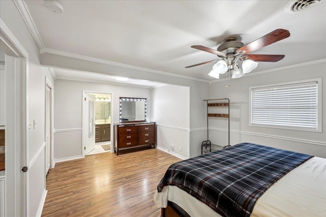 5520 N Circuit Dr, Beaumont, TX 77706 - bedroom with baseboards, visible vents, light wood-style floors, crown molding, and ensuite bath