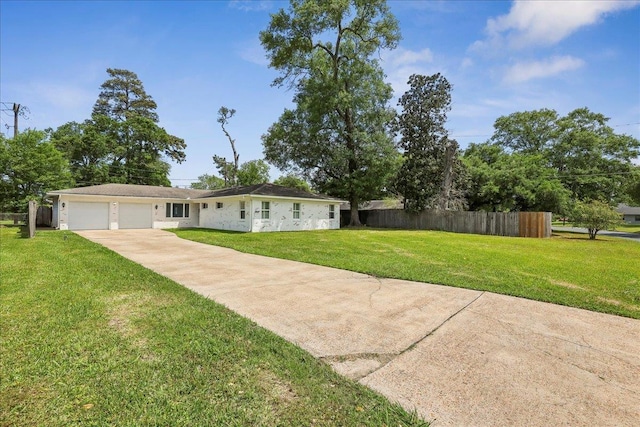 5520 N Circuit Dr, Beaumont, TX 77706 - view of front of house with an attached garage, a front yard, fence, and driveway