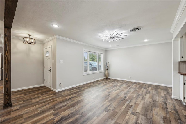 5520 N Circuit Dr, Beaumont, TX 77706 - unfurnished living room featuring dark wood-style floors, a textured ceiling, visible vents, baseboards, and an inviting chandelier