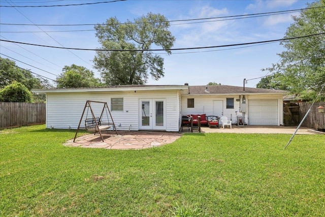 5520 N Circuit Dr, Beaumont, TX 77706 - rear view of house with french doors, fence, a patio area, a lawn, and an attached garage