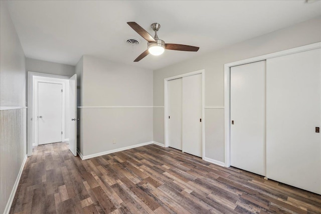 5520 N Circuit Dr, Beaumont, TX 77706 - unfurnished bedroom with two closets, visible vents, baseboards, and wood finished floors
