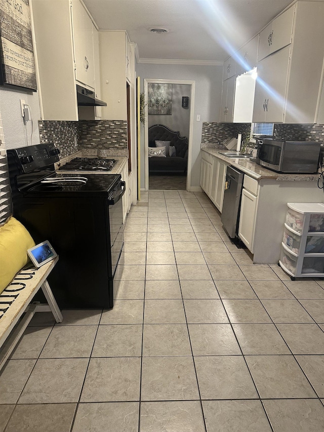 kitchen with decorative backsplash, ornamental molding, stainless steel appliances, light tile patterned floors, and white cabinets