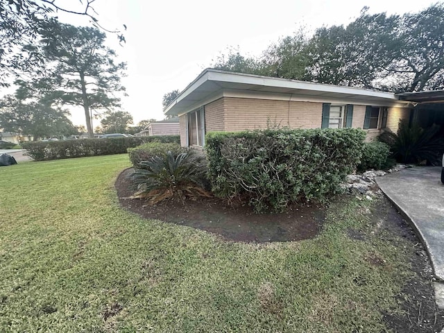 view of side of property featuring a yard