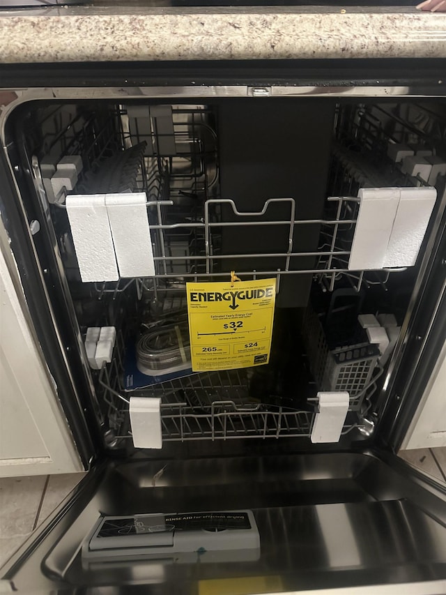 room details with dishwashing machine and white cabinetry