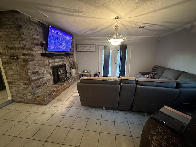 living room with a fireplace, light tile patterned floors, a textured ceiling, and crown molding