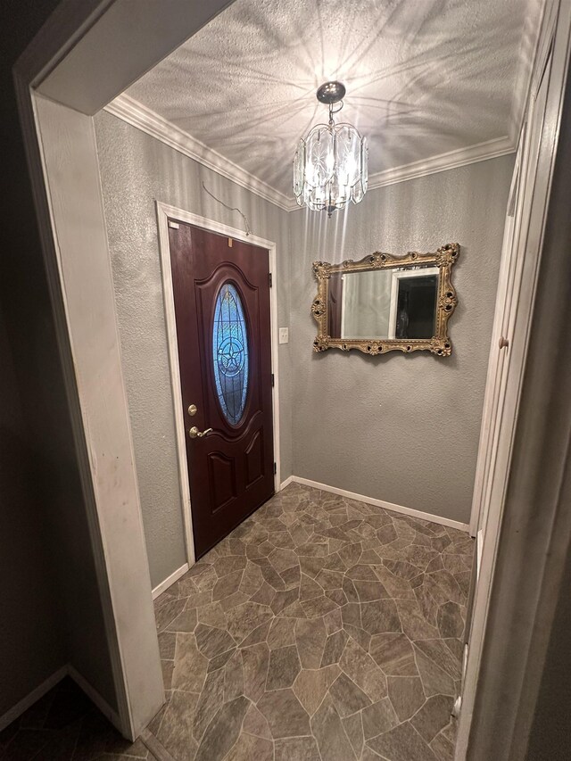 entryway featuring a textured ceiling, crown molding, and a chandelier