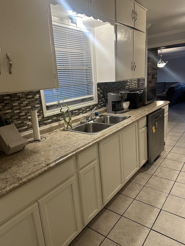 kitchen featuring sink, black dishwasher, backsplash, decorative light fixtures, and light tile patterned floors