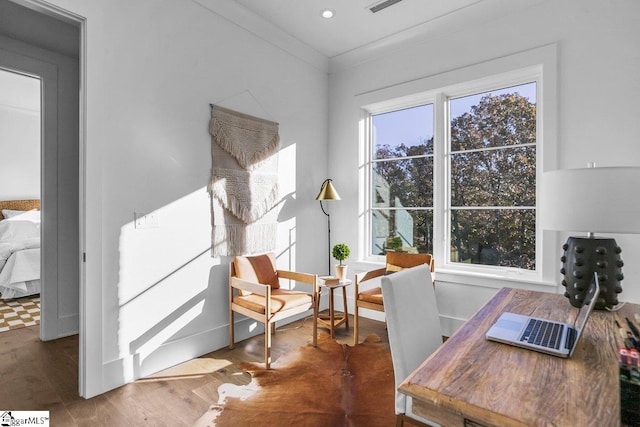 office featuring dark hardwood / wood-style flooring and crown molding