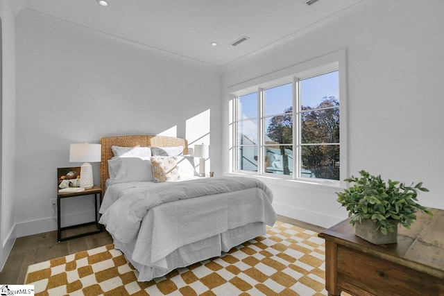 bedroom featuring light hardwood / wood-style flooring and ornamental molding