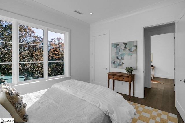 bedroom with dark hardwood / wood-style flooring