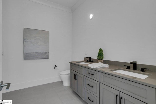 bathroom featuring tile patterned floors, vanity, toilet, and crown molding