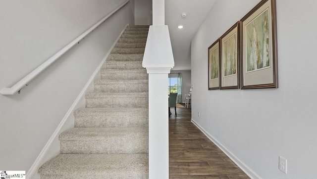 stairway with dark hardwood / wood-style flooring