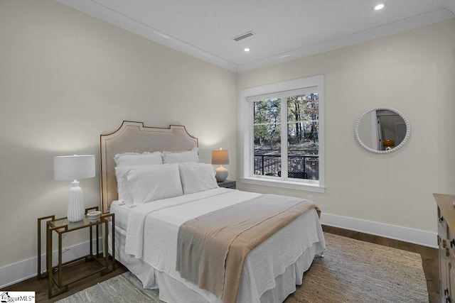 bedroom featuring dark hardwood / wood-style floors and crown molding