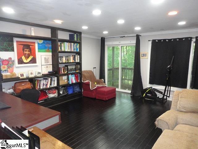 interior space with dark wood-type flooring and ornamental molding