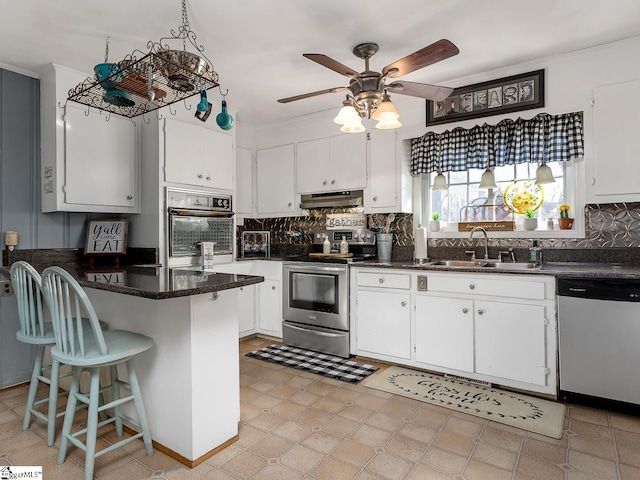 201 White Oak Rd, Woodruff, SC 29388 - kitchen with white cabinetry, ceiling fan, light tile flooring, appliances with stainless steel finishes, and sink