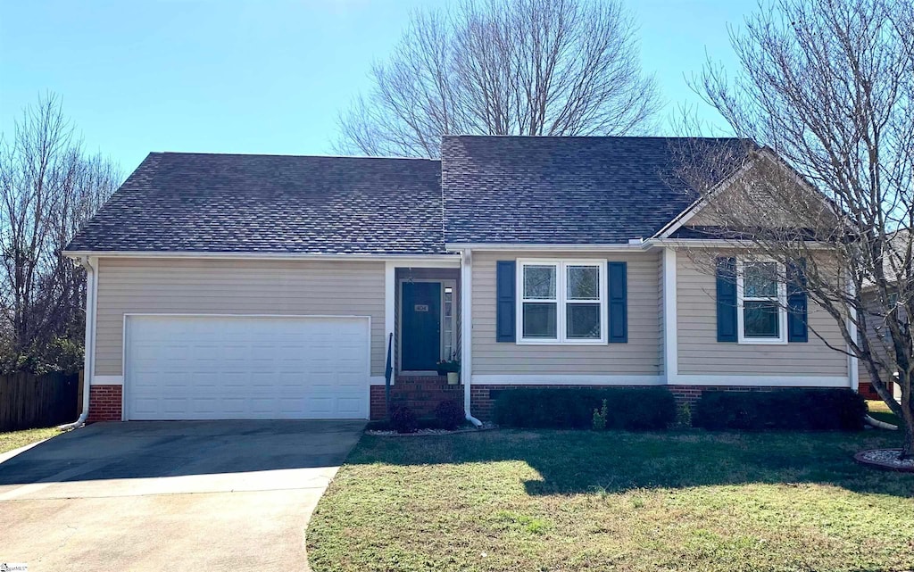 view of front of house featuring a front yard and a garage