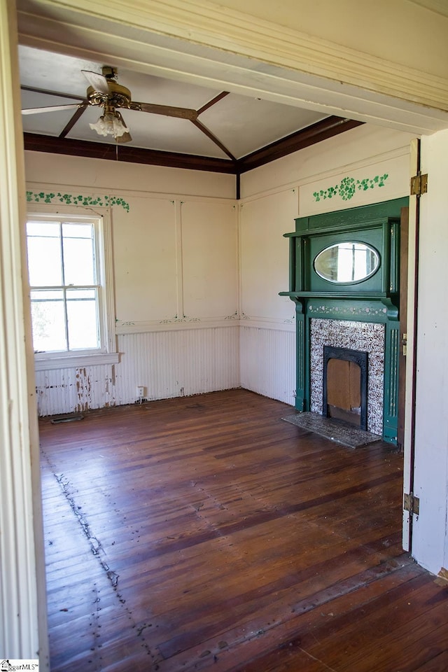 unfurnished living room featuring ceiling fan, lofted ceiling, dark wood-type flooring, and a tiled fireplace