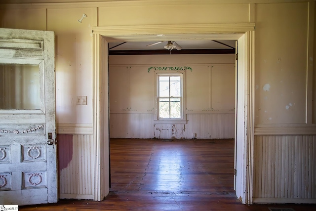 unfurnished room featuring crown molding, ceiling fan, and dark wood-type flooring