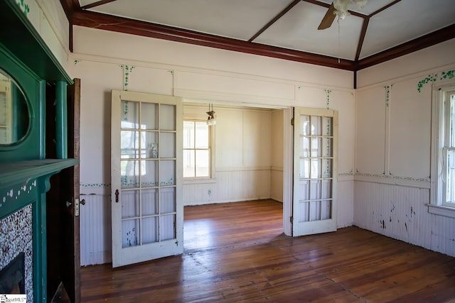 spare room featuring lofted ceiling, ceiling fan, and dark wood-type flooring