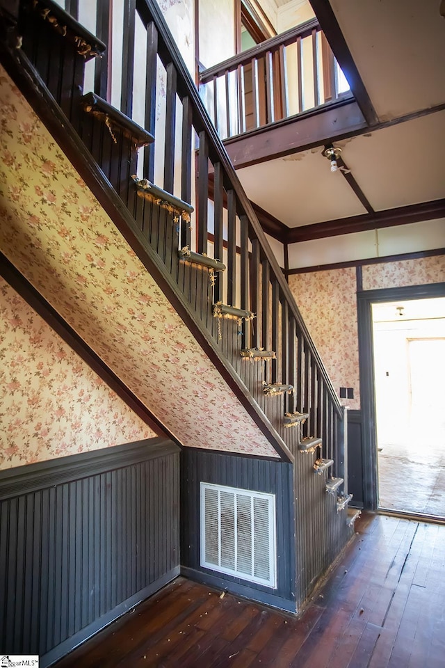 stairs with dark hardwood / wood-style floors, ceiling fan, and ornamental molding