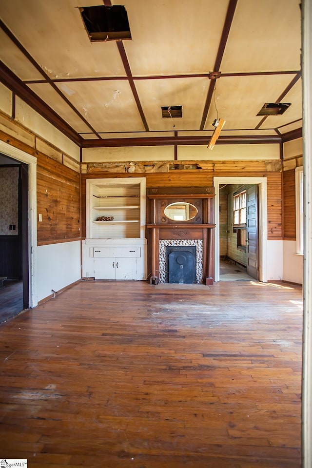 unfurnished living room with dark hardwood / wood-style floors and a fireplace