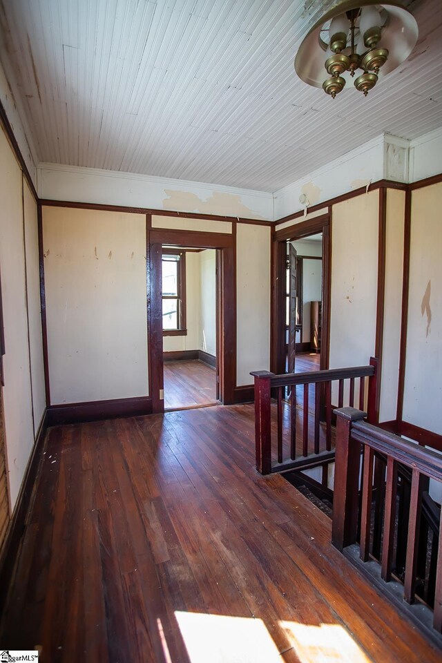 unfurnished room featuring a chandelier, wood ceiling, and dark hardwood / wood-style floors