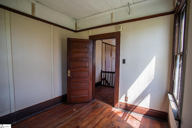 empty room with dark hardwood / wood-style flooring