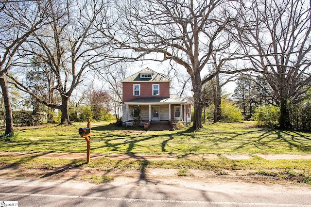 view of front of house featuring covered porch and a front yard