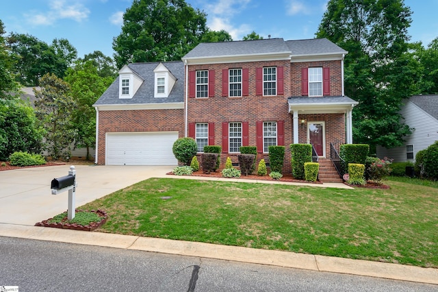 colonial home with a front lawn and a garage