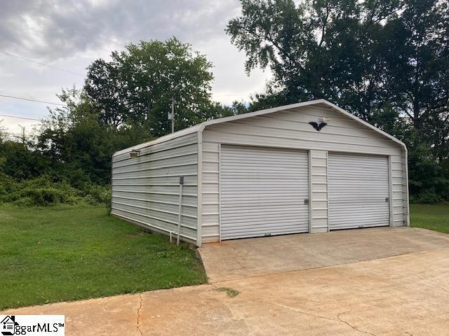 garage featuring a lawn