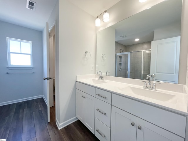 bathroom featuring walk in shower, double sink vanity, and hardwood / wood-style flooring