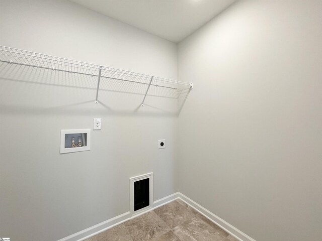 laundry room with electric dryer hookup, washer hookup, and light tile floors