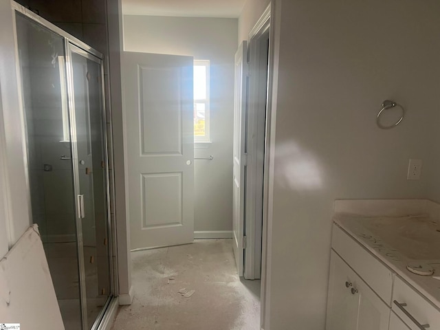 bathroom featuring concrete flooring, vanity, and an enclosed shower